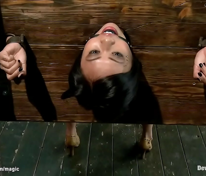 Japanese Enchantress Locked in Wall Stock, Back Arched – Unleash Your Desires!